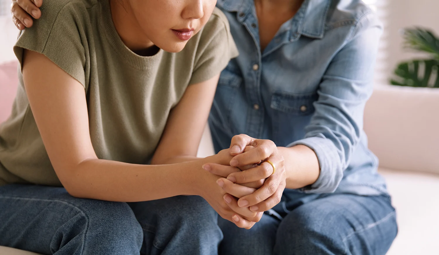 Middle aged asia people old mom holding hands trust comfort help young woman talk crying stress relief at home. Mum as friend love care hold hand adult child feel pain sad worry of life crisis issues.